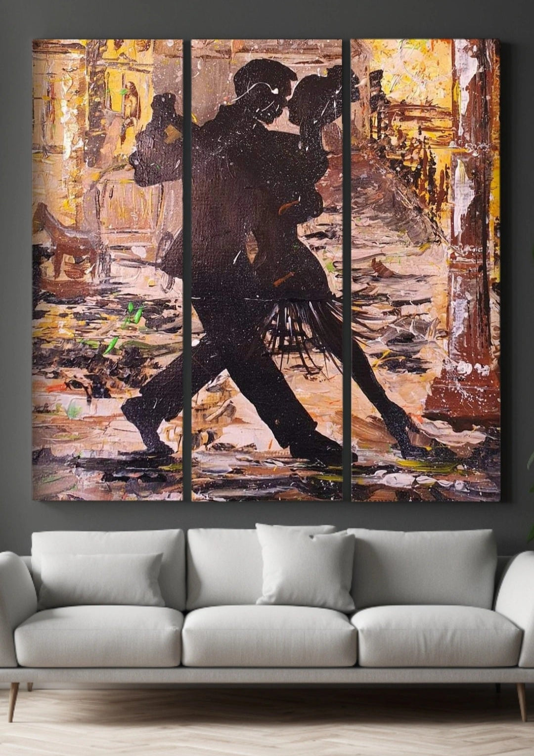 Triptych painting of a couple dancing in an urban setting above a gray sofa.
abstract painting. dance of love. Couples dancing. Paint splatter. Wall decor. Living room decor. interior design.