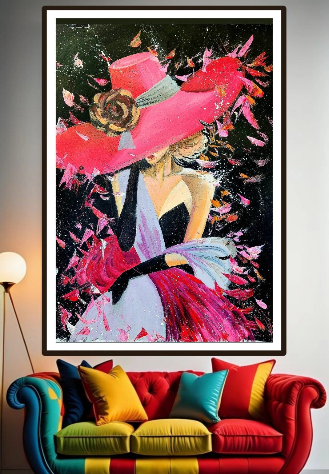 A vibrant artwork of a woman dressed in a crimson hat and dress, with a prominent rose detail, set against a dark background. Painting is hung over a colorful sofa with cushions and lamp. Home and office decor ideas for wall art.