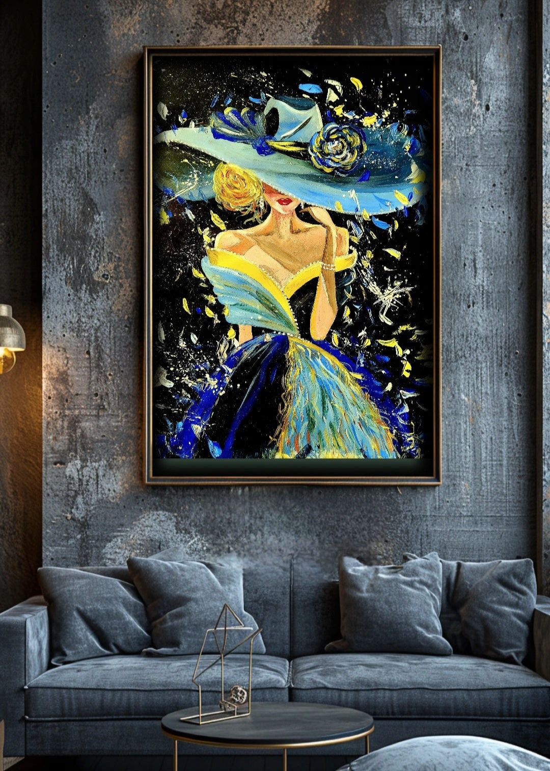 A vibrant framed painting of a woman dressed in a blue and yellow dress with a wide-brimmed hat, adorned with a rose hung on a textured wall over a grey sofa. The painting shows expressive brush strokes, pallet knife and paint splatters. Ideas for home or office decor. Contemporary Art inspirations.