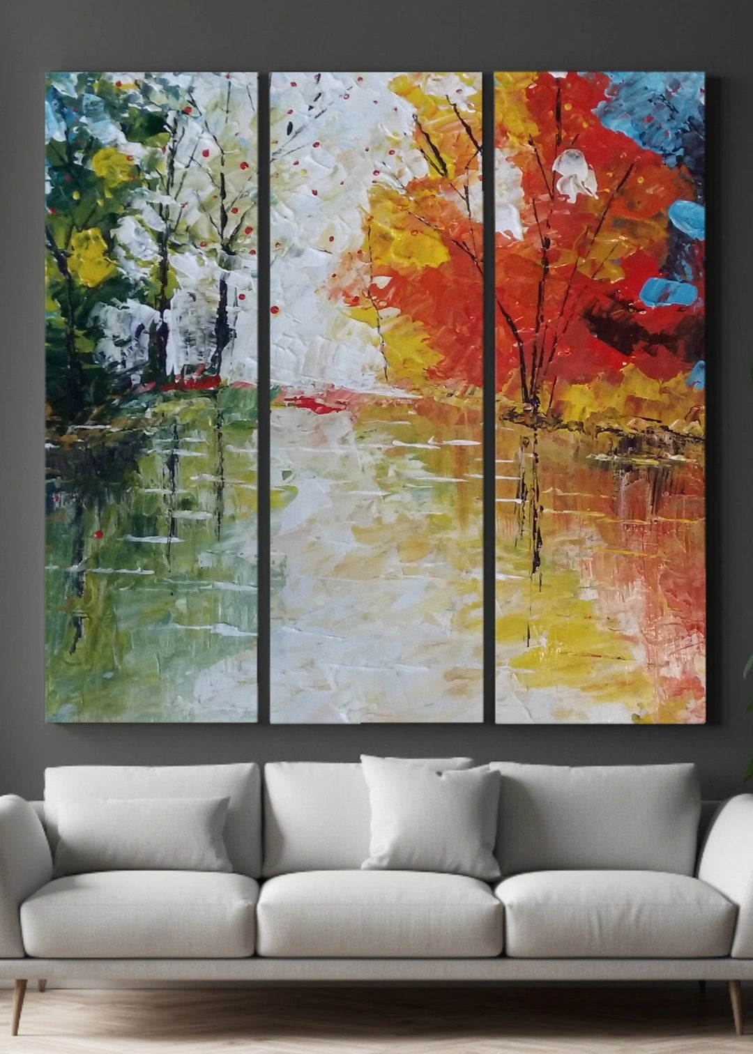 An abstract painting of red, blue trees lining a body of water with the reflections shining through. Bold pallet knife and brush strokes. Home decor. Wall art and art collectors.