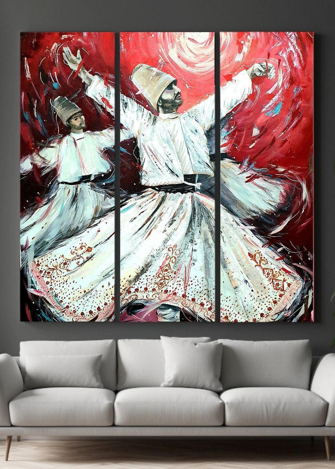 Triptych painting of a dancer with red and white colors on a gray wall above a gray sofa. A vibrant visual artwork featuring two figures in white traditional clothing whirling against a dynamic red background, expressive of the described spiritual and artistic inspirational dance of Rumi. The whirling Dervishes spinning around in a trance like meditation.