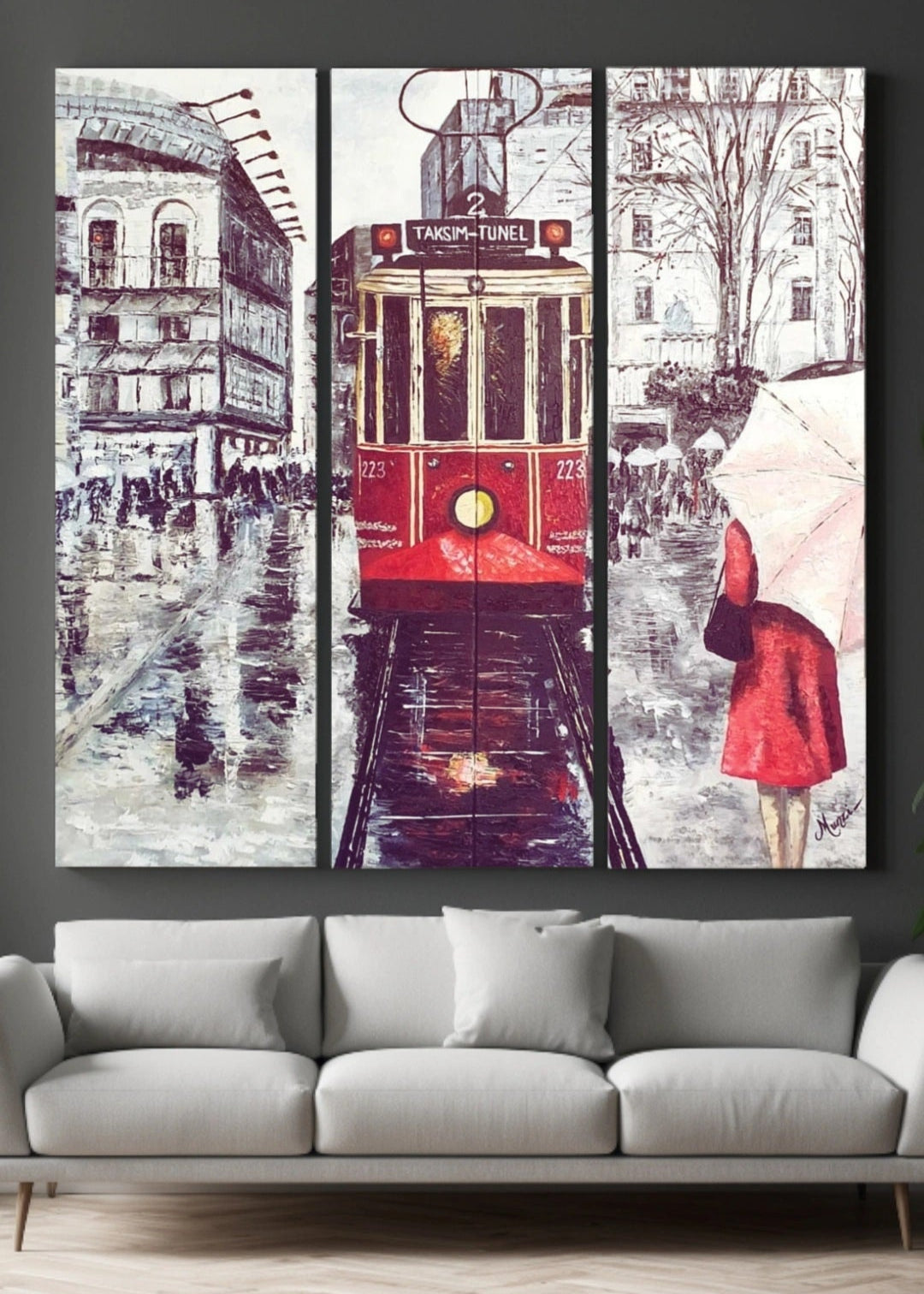A monochrome artwork capturing a rainy night scene at Taksim Square with a red tram and a woman wearing a red coat holding an umbrella. The image has a textured surface and uses a palette knife technique.
