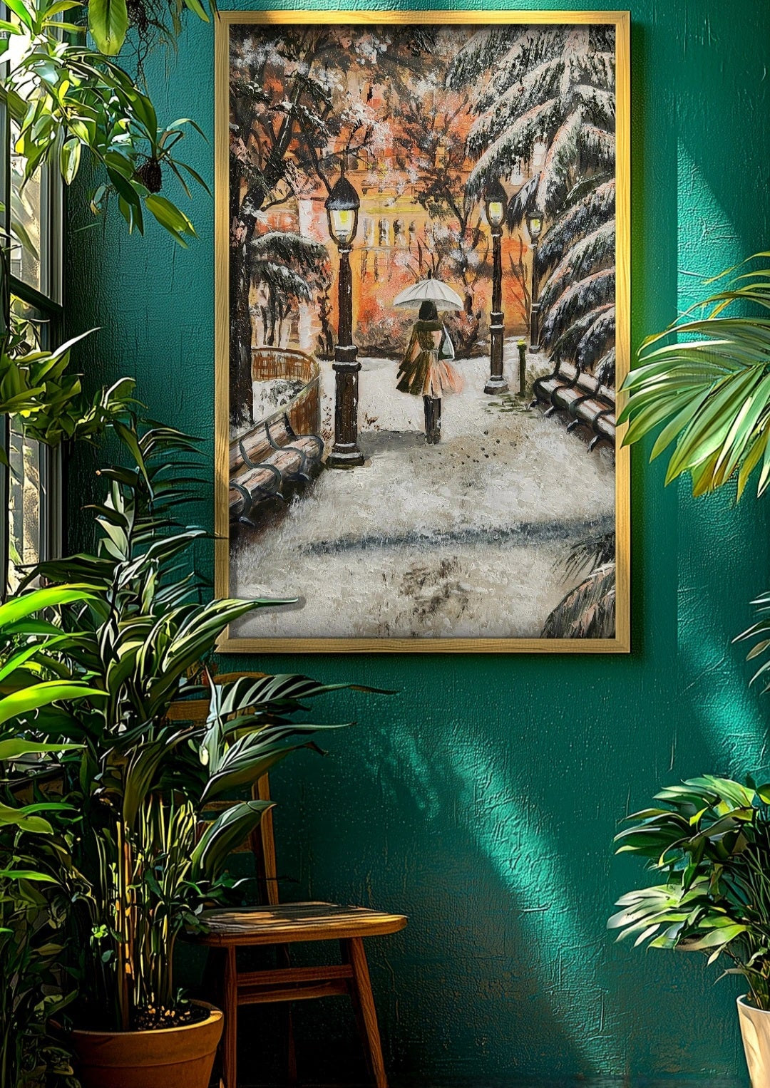 Framed artwork of a snowy street scene on a teal wall with plants around.
Original artwork showing a walking through a snow-covered park with lamp posts and a warm glow in the background. Park benches covered with snow. Winter warmth. Artwork interior decor, home, office, studio, realism painting. Snow falling on tree branches. Orange lights warming the background
