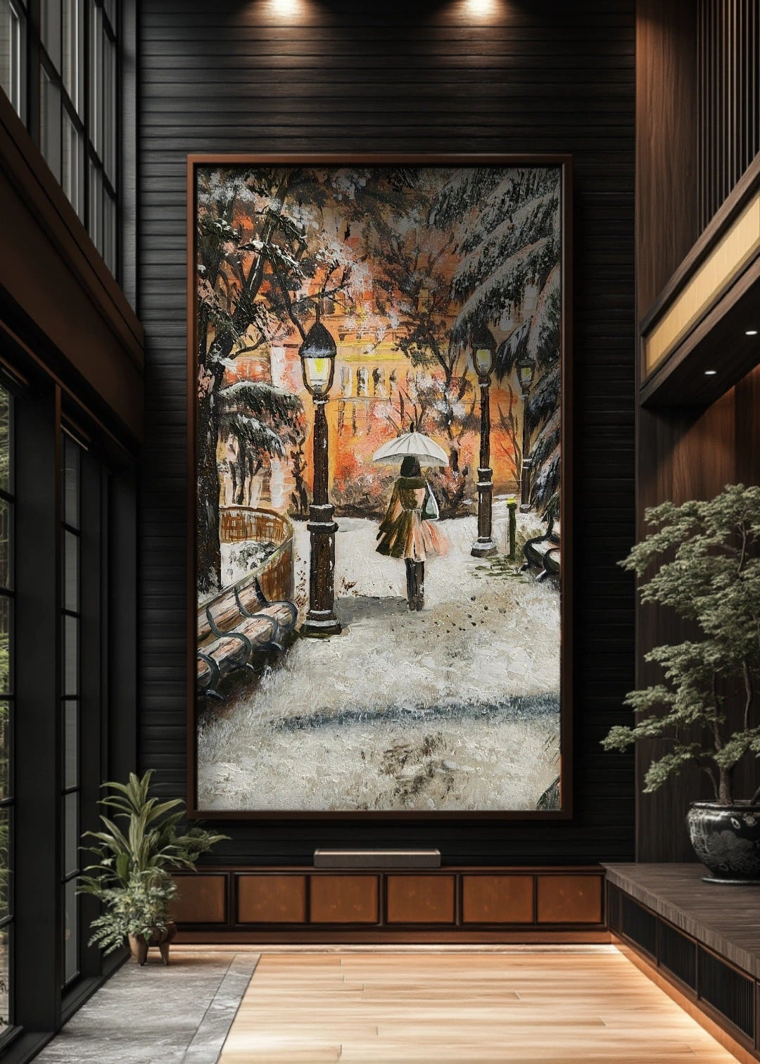 Large painting of a snowy street scene in a modern interior setting. Original artwork showing a walking through a snow-covered park with lamp posts and a warm glow in the background. Park benches covered with snow. Winter warmth. Artwork interior decor, home, office, studio, realism painting. Snow falling on tree branches. Orange lights warming the background