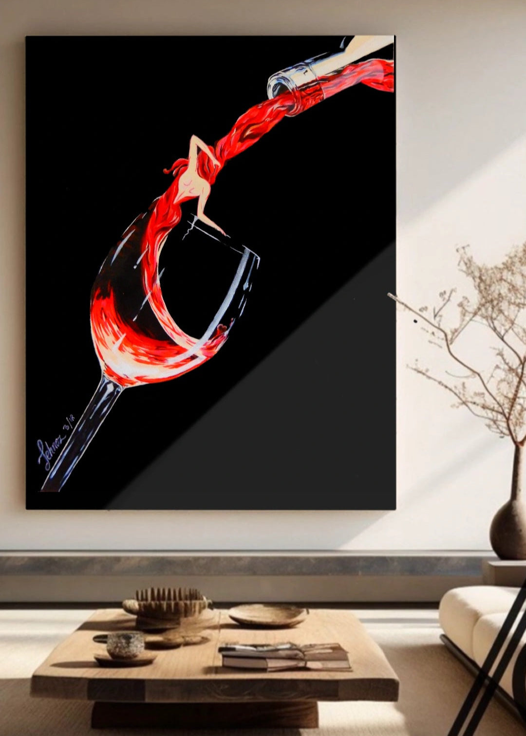 Framed abstract art of a wine glass with red liquid on a wall in a living room.