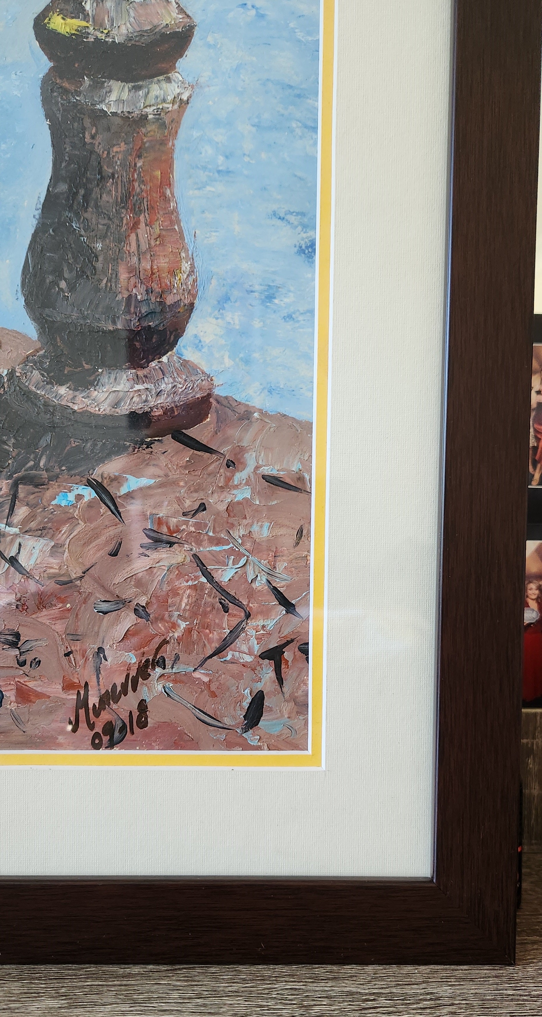 Framed abstract painting with a signature on a textured surface